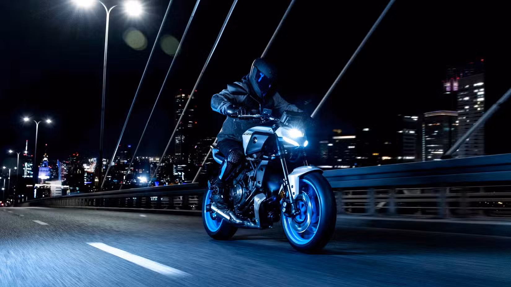 A 2025 Yamaha MT-07 being ridden in the city at night