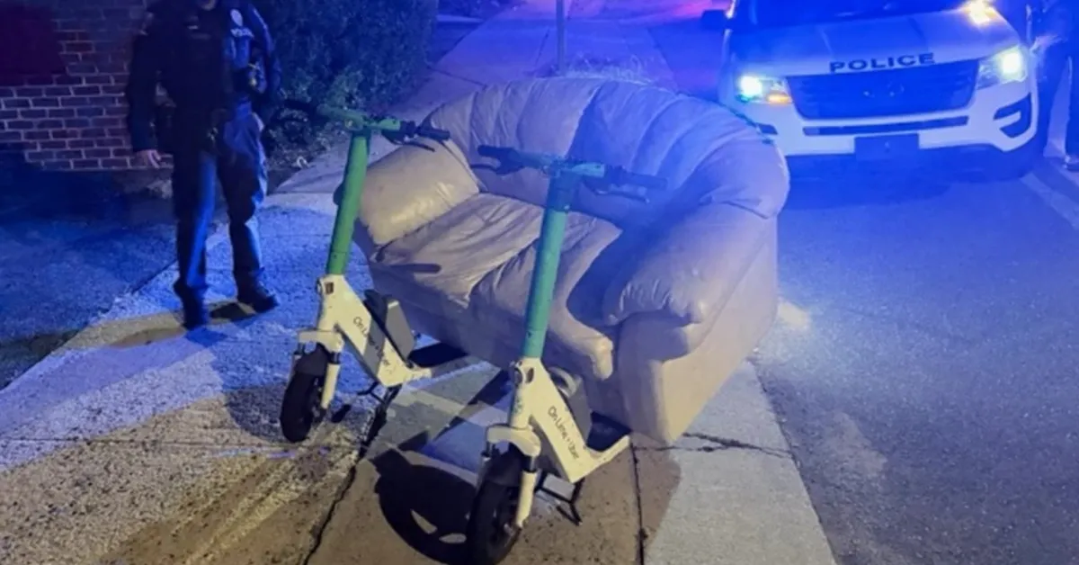 Police pull over two men riding an electric couch down the street